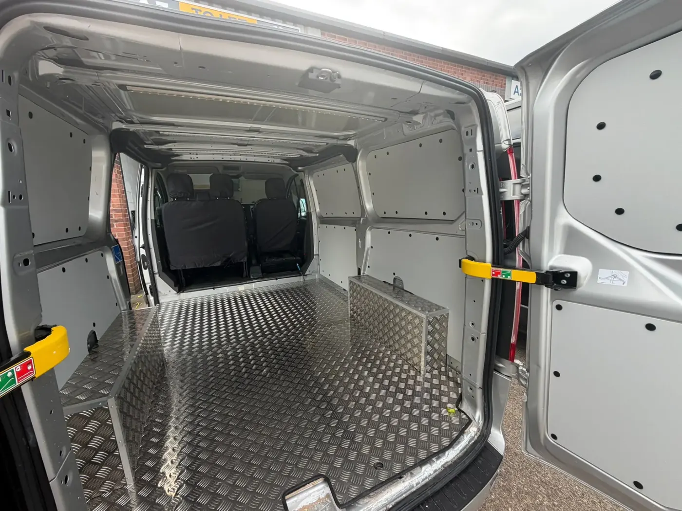 Van load area with lined walls and chequer plate flooring